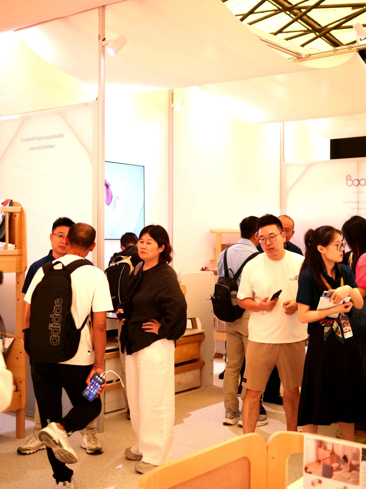 visitors exploring Boori sustainably sourced wooden kids furniture at trade show visitors exploring Boori sustainably sourced wooden kids furniture at trade show